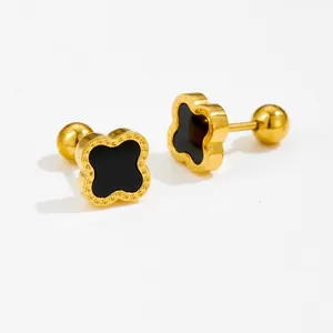 Detailed macro view of gold clover stud earrings with black inlay and screw-back closure
