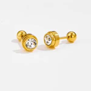 Macro detail of gold barbell stud earrings with round clear crystal and screw back