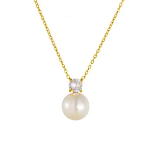 Elegant gold necklace with a round white pearl and sparkling round gemstone pendant