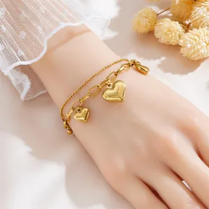 Elegant gold-tone double-layered stainless steel bracelet with heart charms for women