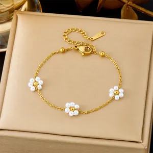 Gold 18K plated stainless steel bracelet with dainty white pearl flowers and S.Steel tag