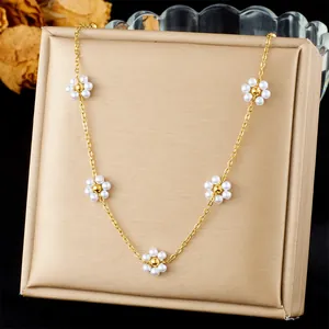 Close-up of elegant 18K gold-plated stainless steel necklace with five pearl daisy charms