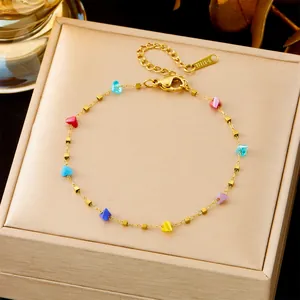 Gold stainless steel bracelet featuring colorful heart-shaped beads and lobster clasp