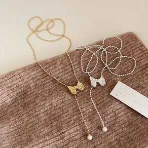 French vintage metallic bow necklace with delicate bead chain and pearls in gold and silver
