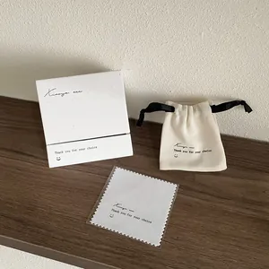 Coffret cadeau bijoux minimaliste avec boîte blanche, pochette beige et carte de vœux