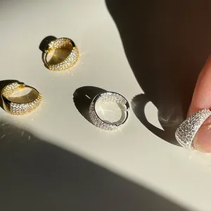 Macro shot of sparkling gold and silver earrings with micro-pave cubic zirconia stones