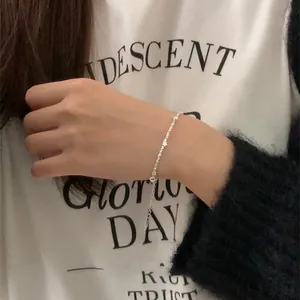 Close-up of minimalist silver star pendant bracelet on wrist for an elegant casual look