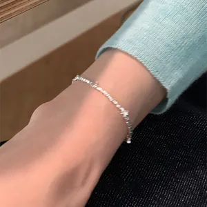 Detailed view of silver star bracelet with sparkling zircons on a model wrist