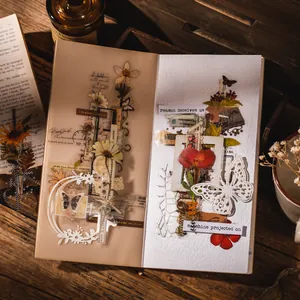 Vintage scrapbooking material set with dried flowers and butterfly stickers on wood