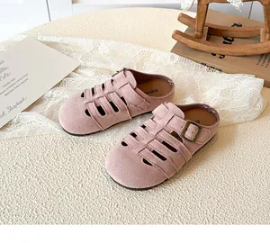 Macro detail of pink hollowed-out girls' princess sandals with metal buckle strap