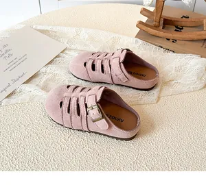 Detailed view of pink suede girl shoes with vintage metal buckles and soft lining