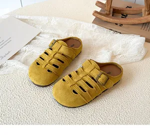 Close-up of yellow hollow braided girl sandals with retro metal buckle on white lace