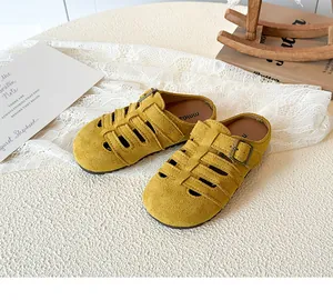 Detail of yellow hollow braided suede slippers for girls with metal adjustable buckle