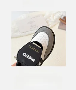 Vue détaillée des baskets fille avec bande velcro et dessus en cuir synthétique cousu