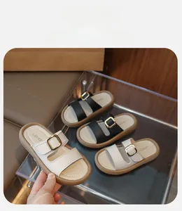 Detailed view of kids stylish slippers with double straps and golden metal buckles