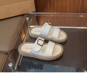 Detailed macro view of white leather straps with golden buckles on non-slip soft rubber soles