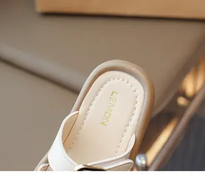 Detail of soft beige inner sole with LEMON logo and white stitching on girls' sandals