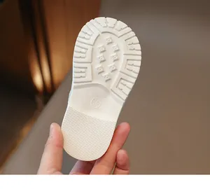 Close-up of non-slip rubber sole with grooved patterns and size mark on girl's shoes