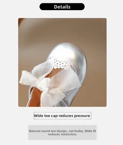 Detailed view of silver girl's princess shoes with a white lace bow and hollow pattern