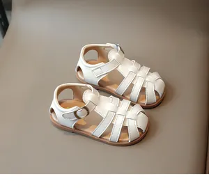 Detailed view of white woven leather upper and protective toe design for kids sandals
