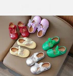 Detailed view of colorful patent leather Mary Jane shoes with mesh bows for girls