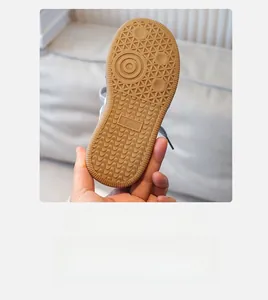 Close-up of children's sport shoe brown rubber sole with anti-slip geometric pattern