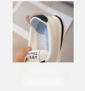Detail view of children's white leather sneakers showing soft blue breathable mesh lining