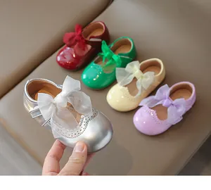 Close-up of girls' Mary Jane shoes with mesh bows and scalloped details in multiple colors
