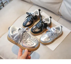 Detail view of kids sports sneakers with sparkly laces and retro patterned leather