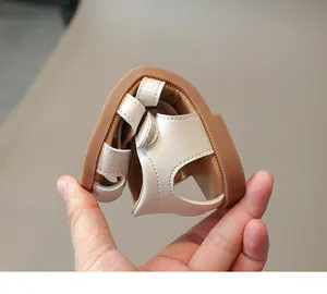 Flexible and soft beige leather children's sandals showing durable non-slip rubber soles