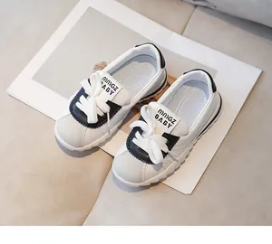 Detail of kids sneakers showing quilted texture and black suede toe panels