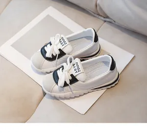Detail view of toddler sneakers with non-slip serrated soles and soft faux leather upper
