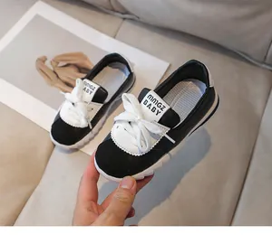 Detail of kids black and white sneakers with leather patchwork and thick sawtooth soles