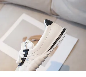 Detail of kids casual sneaker featuring wave-shaped thick sole and black heel patch