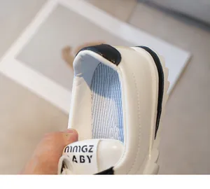 Detailed close-up of white kids' sneaker with breathable mesh lining and heel detail