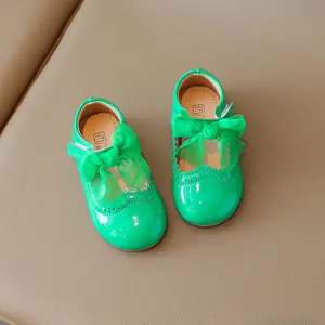 Glossy green patent leather toddler princess shoes with bow and brogue details