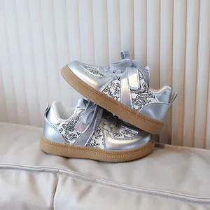 Kids metallic silver sneakers with floral pattern and brown rubber gum outsole