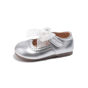 Silver Mary Jane shoes for girls with large organza bow and brogue cutout details