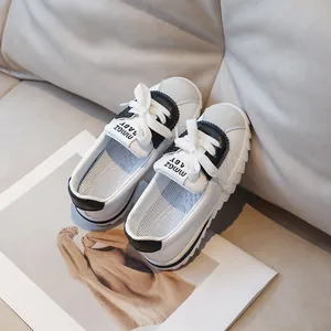 Children's fashion sneakers in black and white with thick soles and soft leather finish