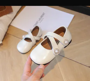 Detail von weißem Mädchen-Mary-Jane-Schuh mit eleganter Perlen- und Strassblütenschnalle