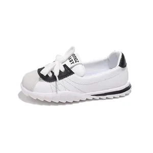 Kids black and white shell-toe sneakers with thick rubber soles and stripes