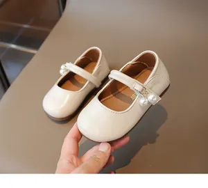 Detailed view of cream Mary Jane shoe for toddlers with pearl accents and buckle strap