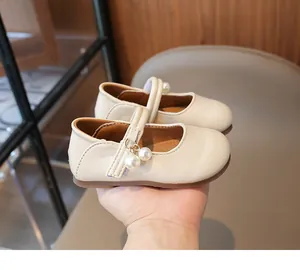Close-up of cream white Mary Jane shoes for girls featuring elegant pearl strap details