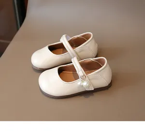 Detailed top view of cream Mary Jane girls' shoes with pearl charms and non-slip rubber soles