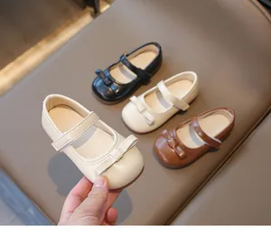 Detail of girls Mary Jane shoes with bow decoration and adjustable velcro strap