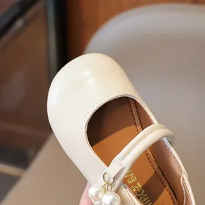 Elegant cream Mary Jane shoes for girls featuring pearl charms and a soft leather finish