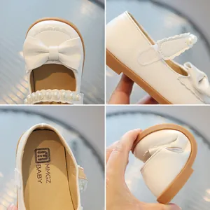White girls Mary Jane shoes with large bow, pearl strap, and flexible soft rubber sole