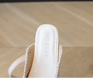 Close-up of pearl slipper insole with MG BABY logo and tweed fabric details