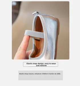 Detail of silver Mary Jane shoe showing the elastic strap for easy slip-on wear