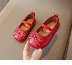 Detailed close-up of matte red girls Mary Jane flats with bow and elastic strap